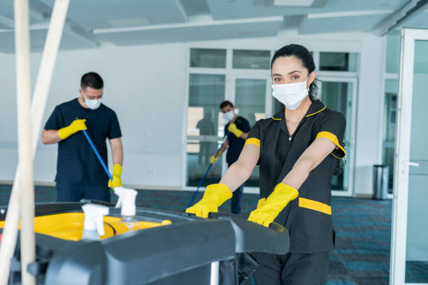 Cleaning staff composed of men and women of Latino ethnicity between the ages of 20-30 are cleaning the building to avoid the risk of contagion by COVID-19